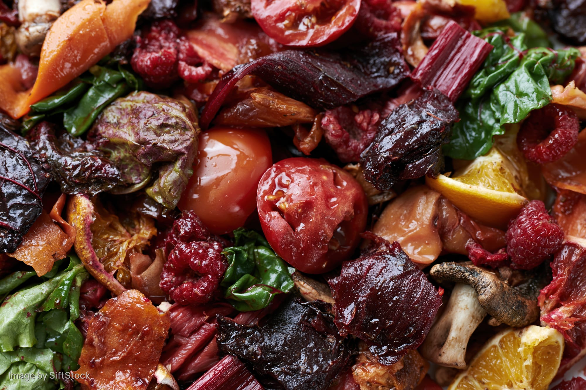 Close-up of mixed vegetable and fruit scraps piled together for composting