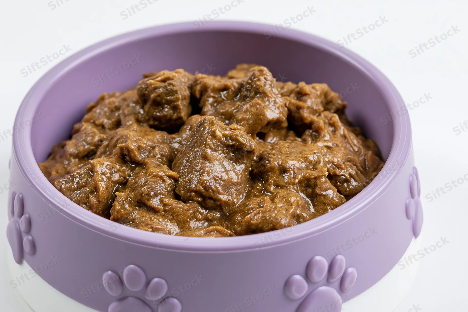 Wet pet food in a purple and white bowl with embossed paw prints