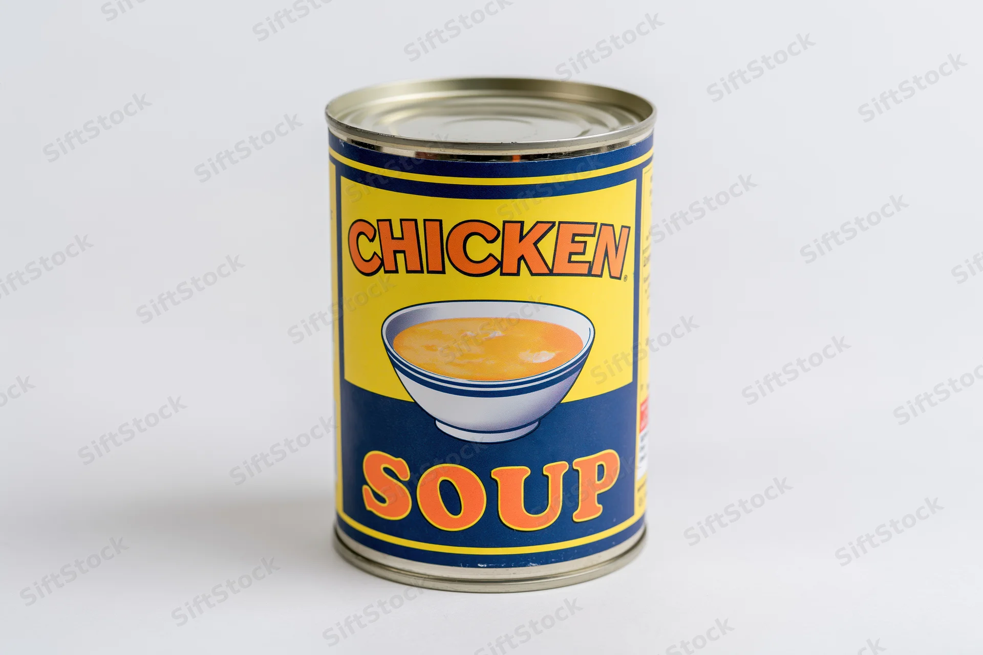 A tin can of chicken soup with a yellow and blue label standing upright on a white surface