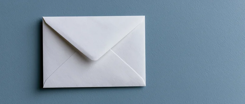 White paper envelope centered on blue textured surface with copyspace to the right