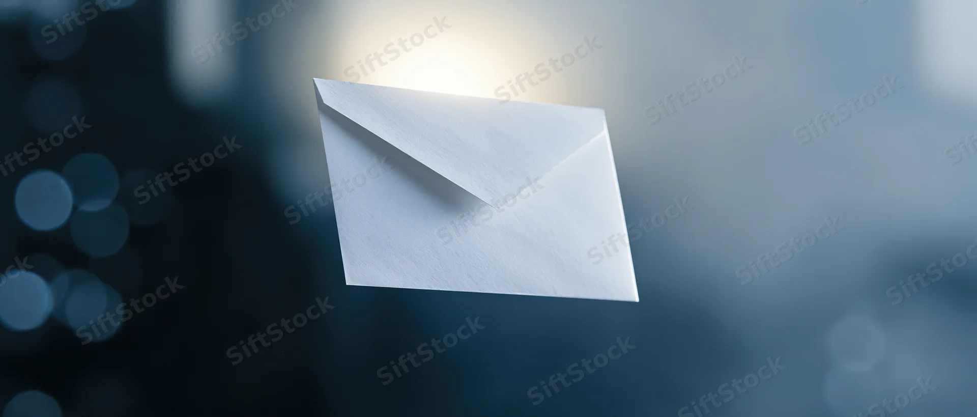 White paper envelope floating against a blurred blue background with soft light glow