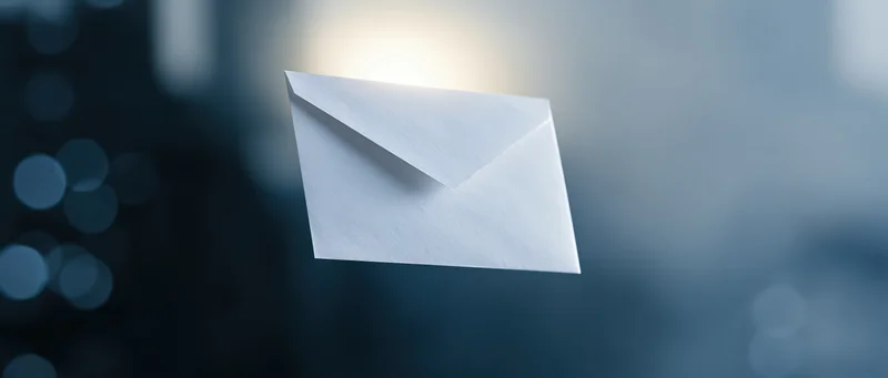 White paper envelope floating against a blurred blue background with soft light glow