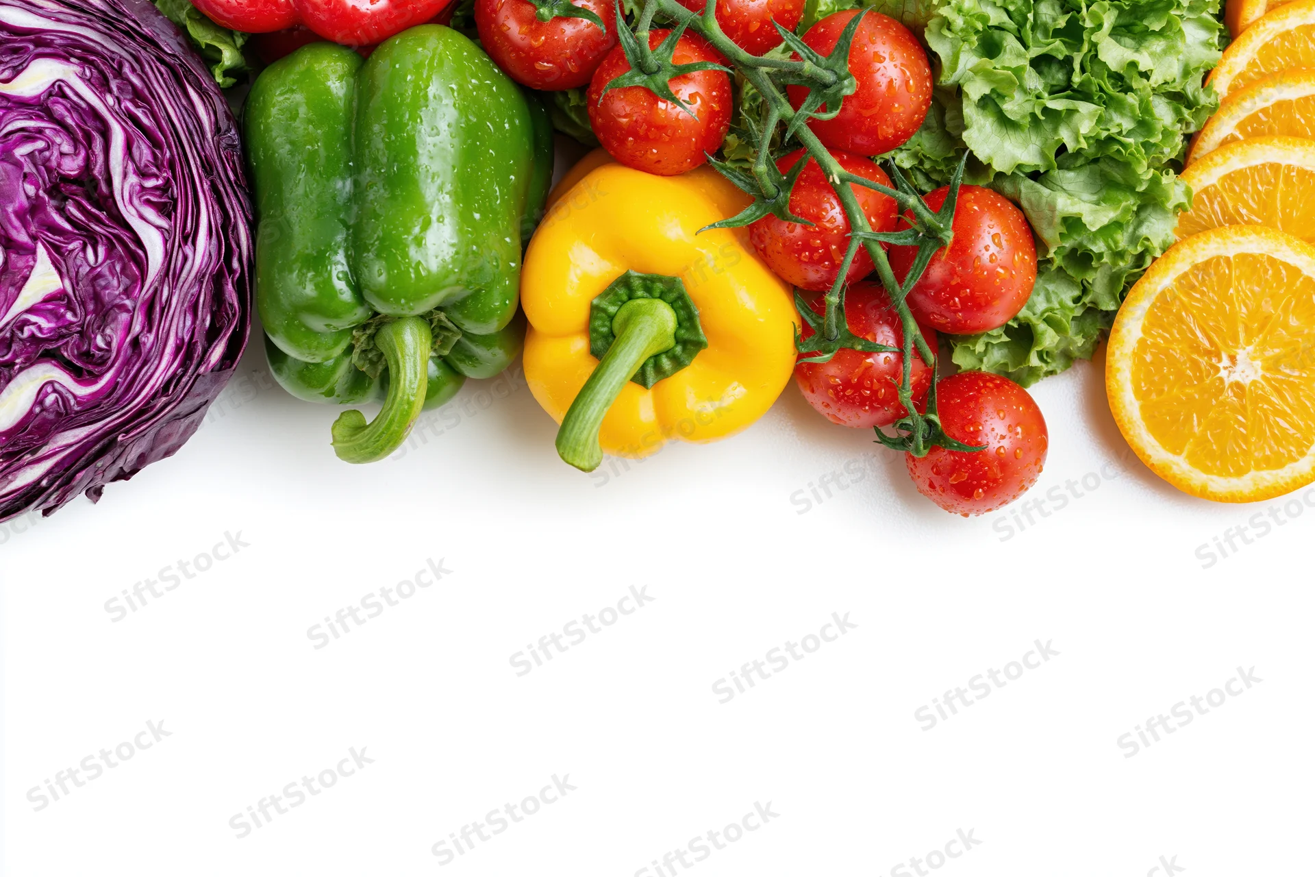 Fresh vegetables and fruits arranged along the top edge on white background