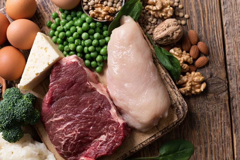 High-protein foods arranged on a rustic wooden table