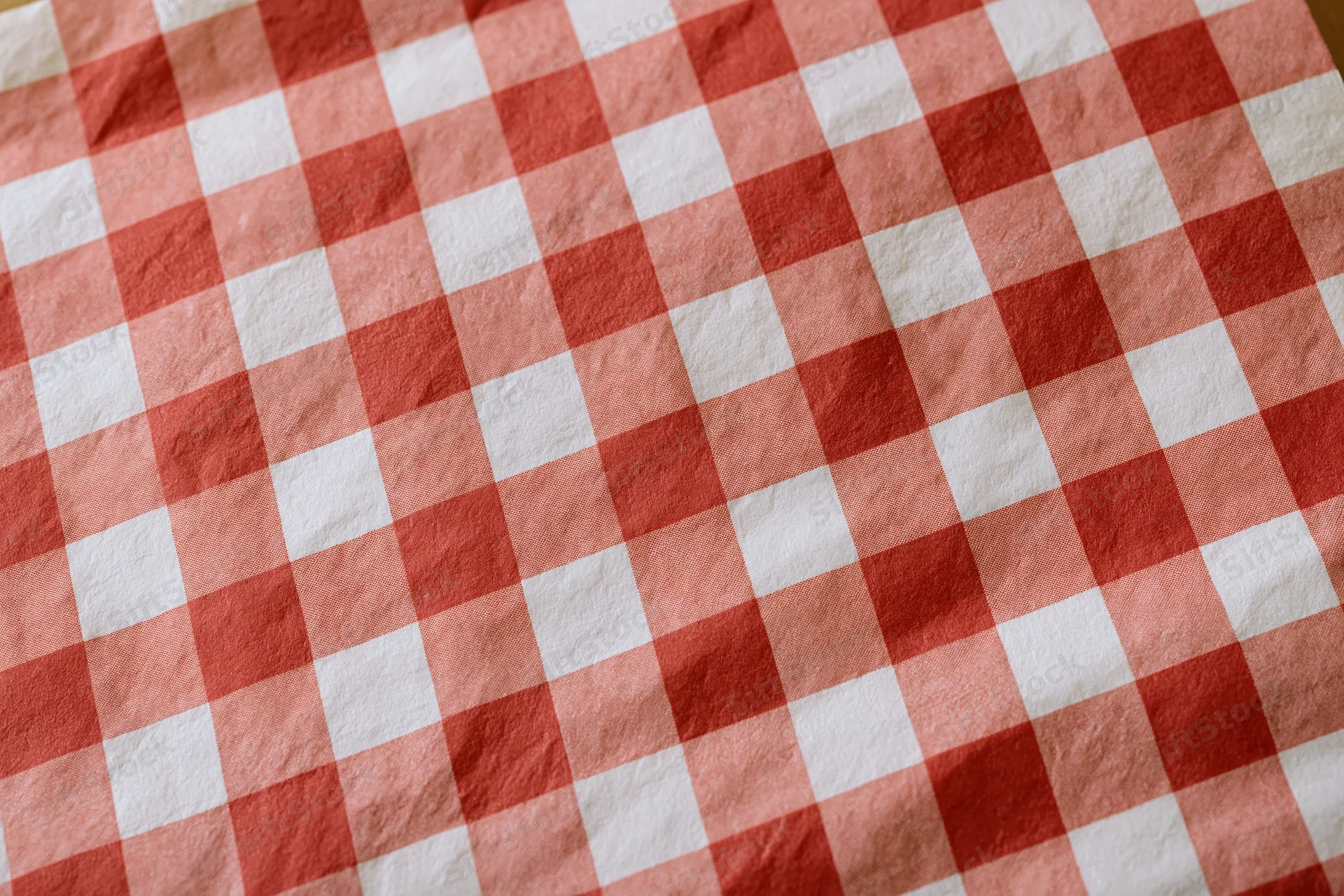 Close-up of red and white checkered paper food liner laid flat on a surface