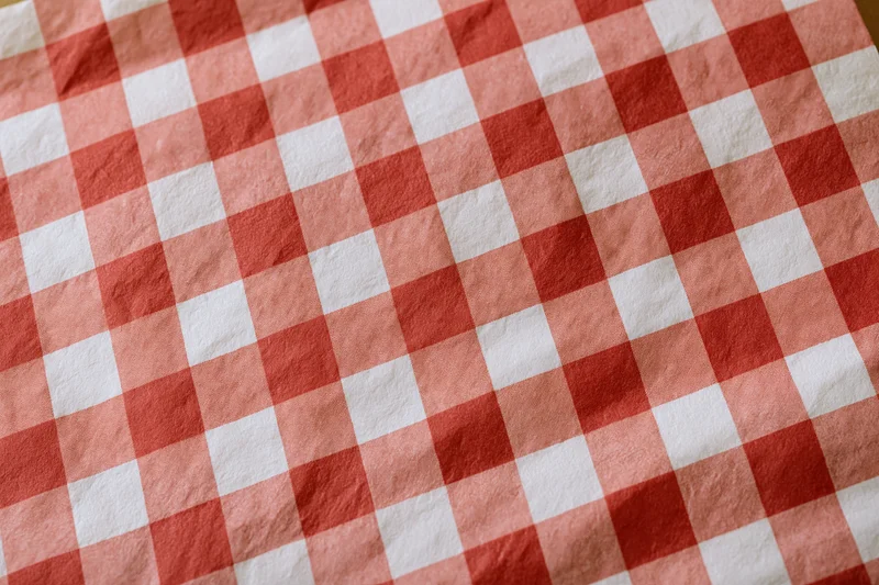 Close-up of red and white checkered paper food liner laid flat on a surface