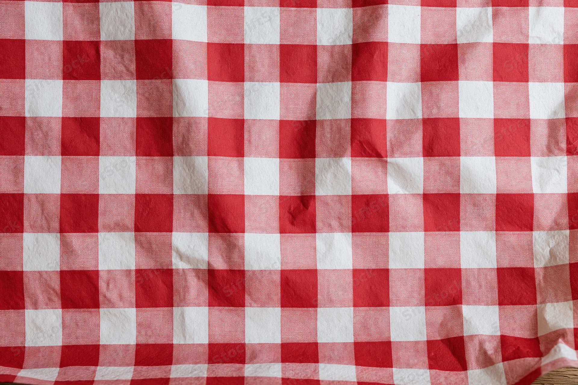 Red and white checkered paper food liner spread flat on a surface