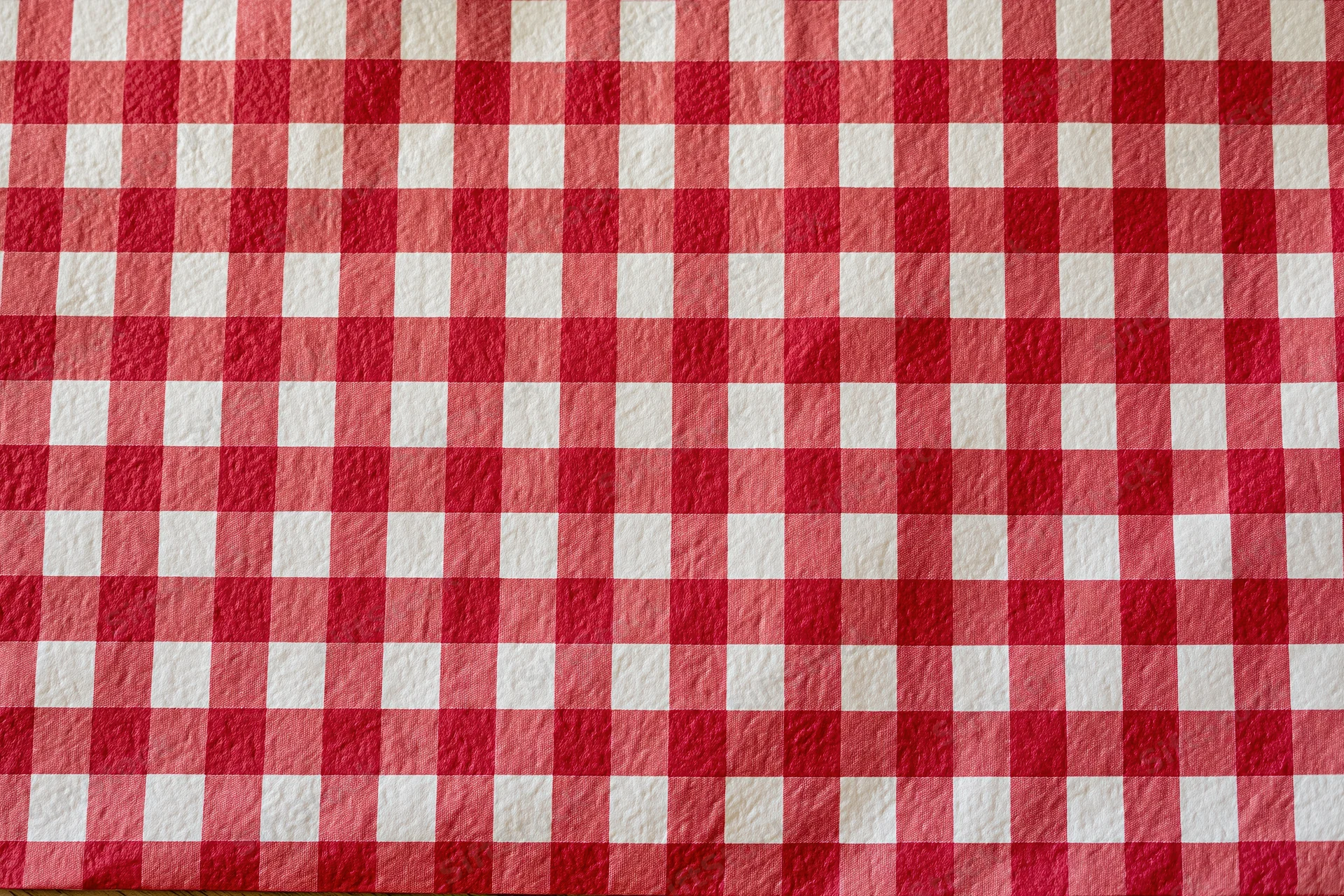 Red and white checkered paper food liner laid flat on a surface