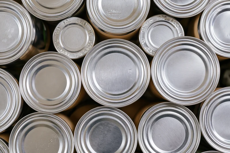 Metal food cans arranged tightly in a top-down view