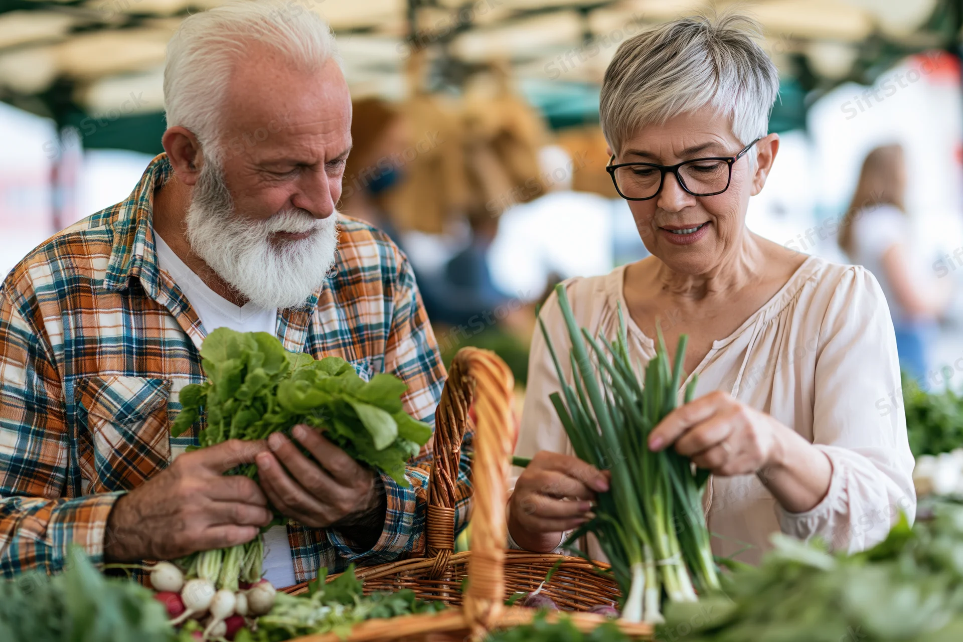 Elderly couple selecting fresh vegetables at an outdoor market