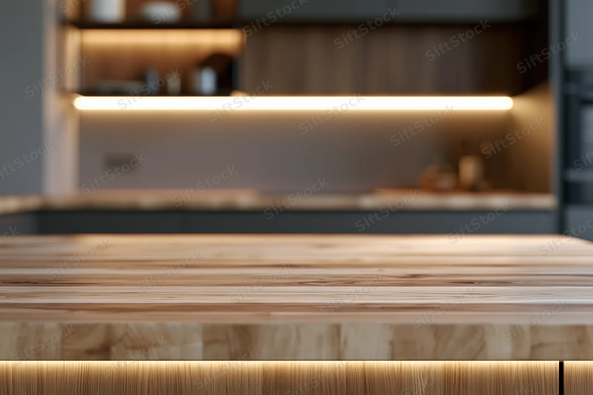 Wooden countertop in sharp focus with blurred kitchen background