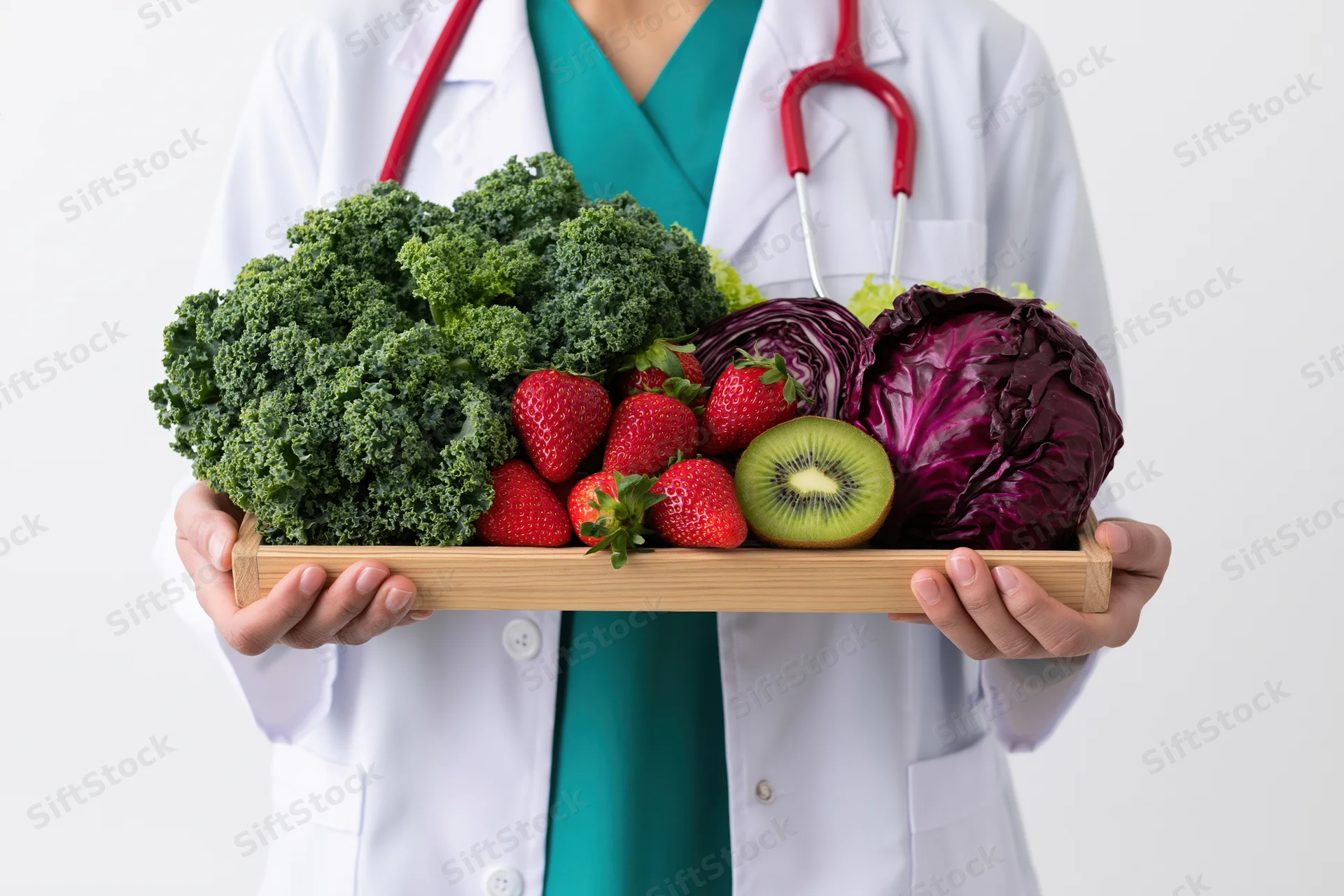 Female doctor holding wooden tray with fresh vegetables and fruits in white coat