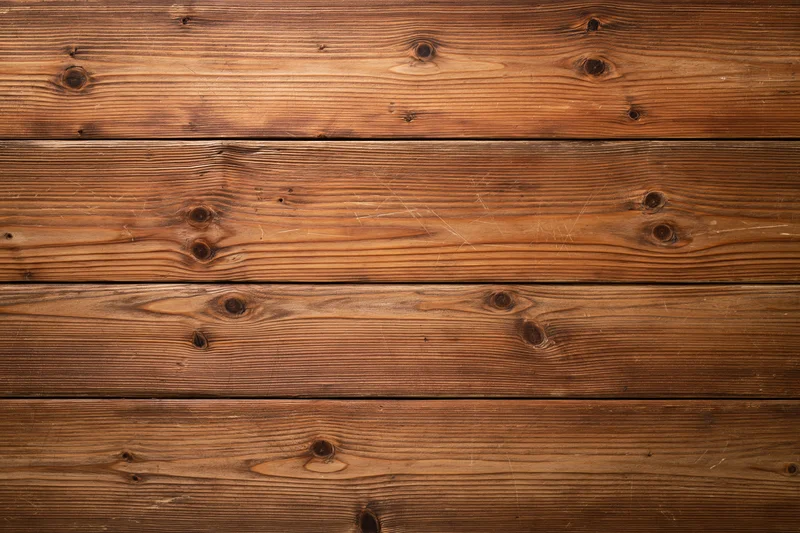 Horizontal wooden planks forming a textured surface with visible grain and knots
