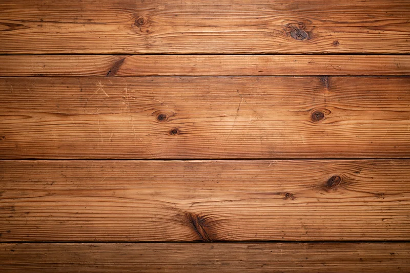 Horizontal wooden planks forming a textured surface with visible grain and knots