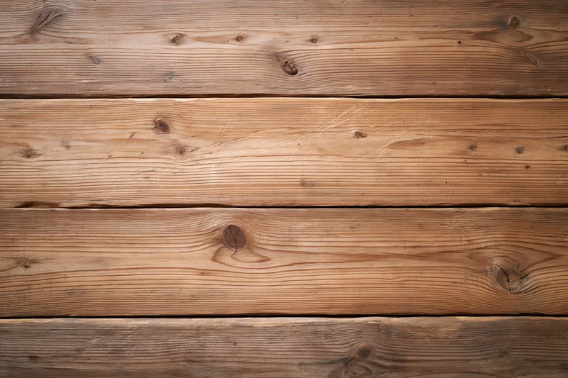 Horizontal wooden planks forming a textured surface with visible grain and knots