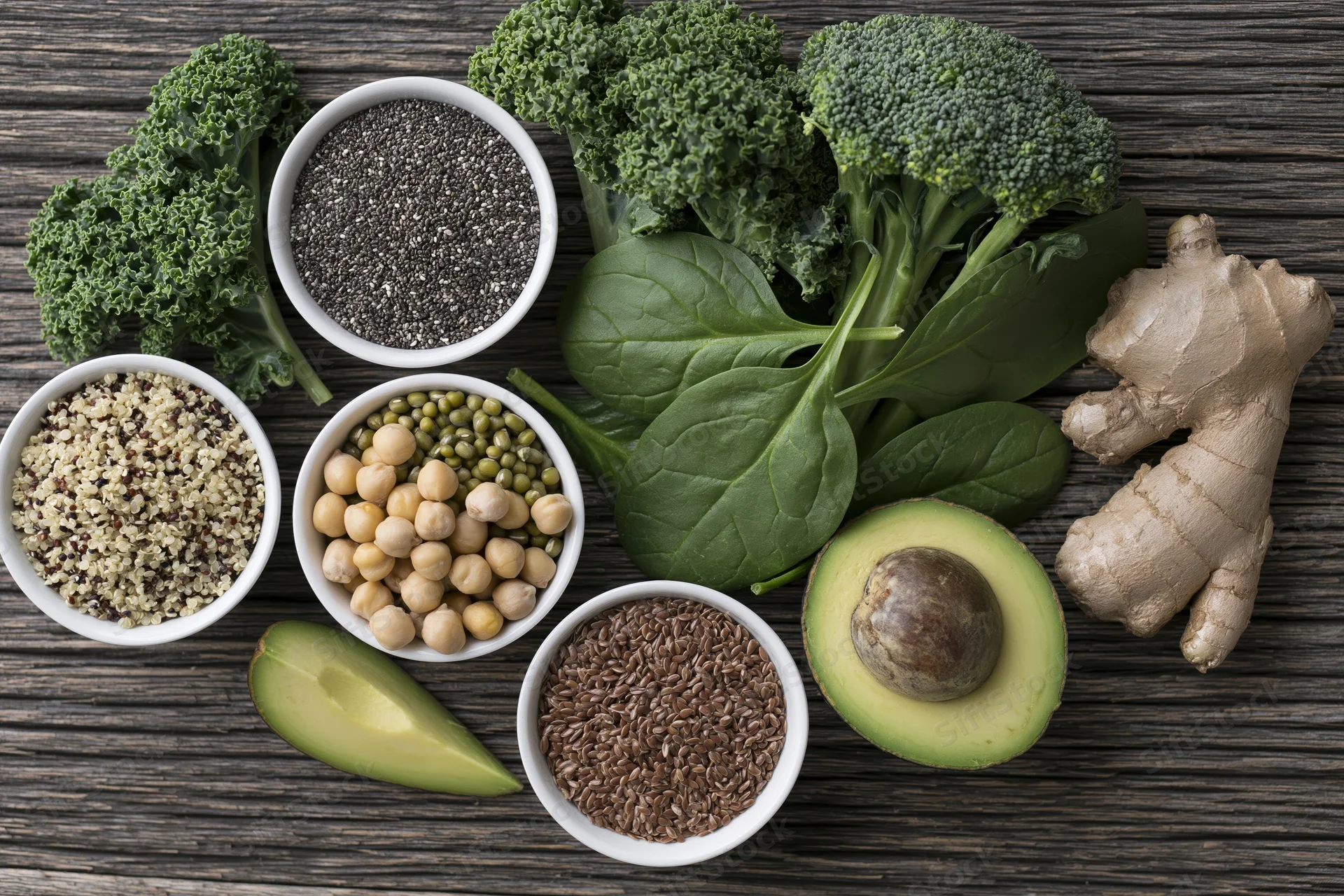 Assorted superfoods arranged on dark weathered wood surface