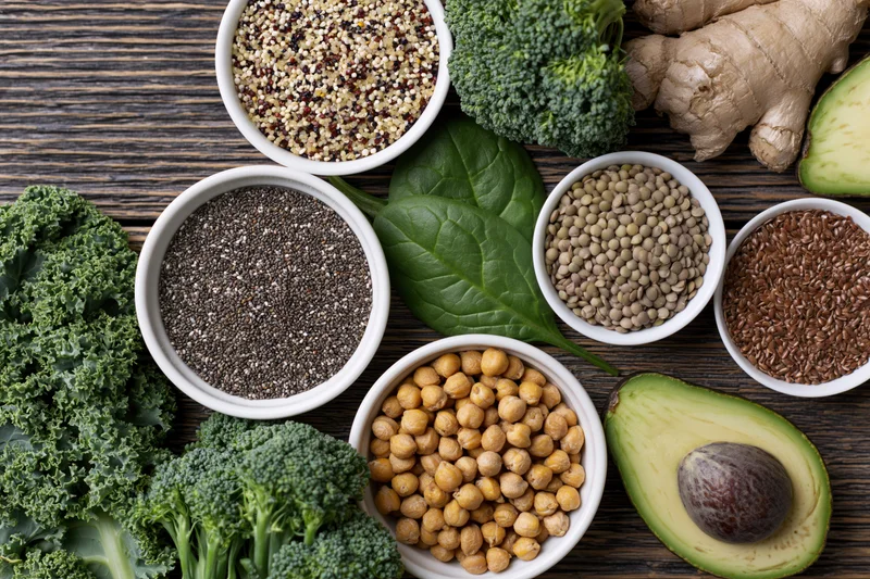 Assorted superfoods arranged in bowls and on a dark wooden surface