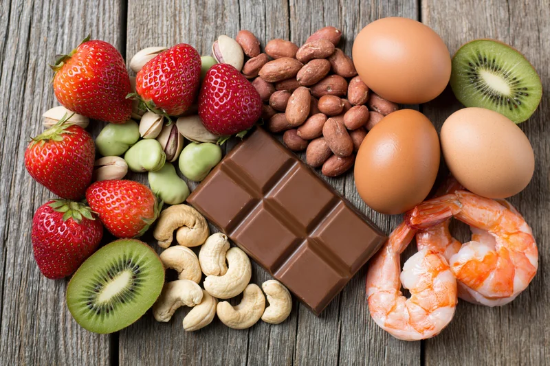 Common food allergens arranged in a flat lay on a weathered wooden surface