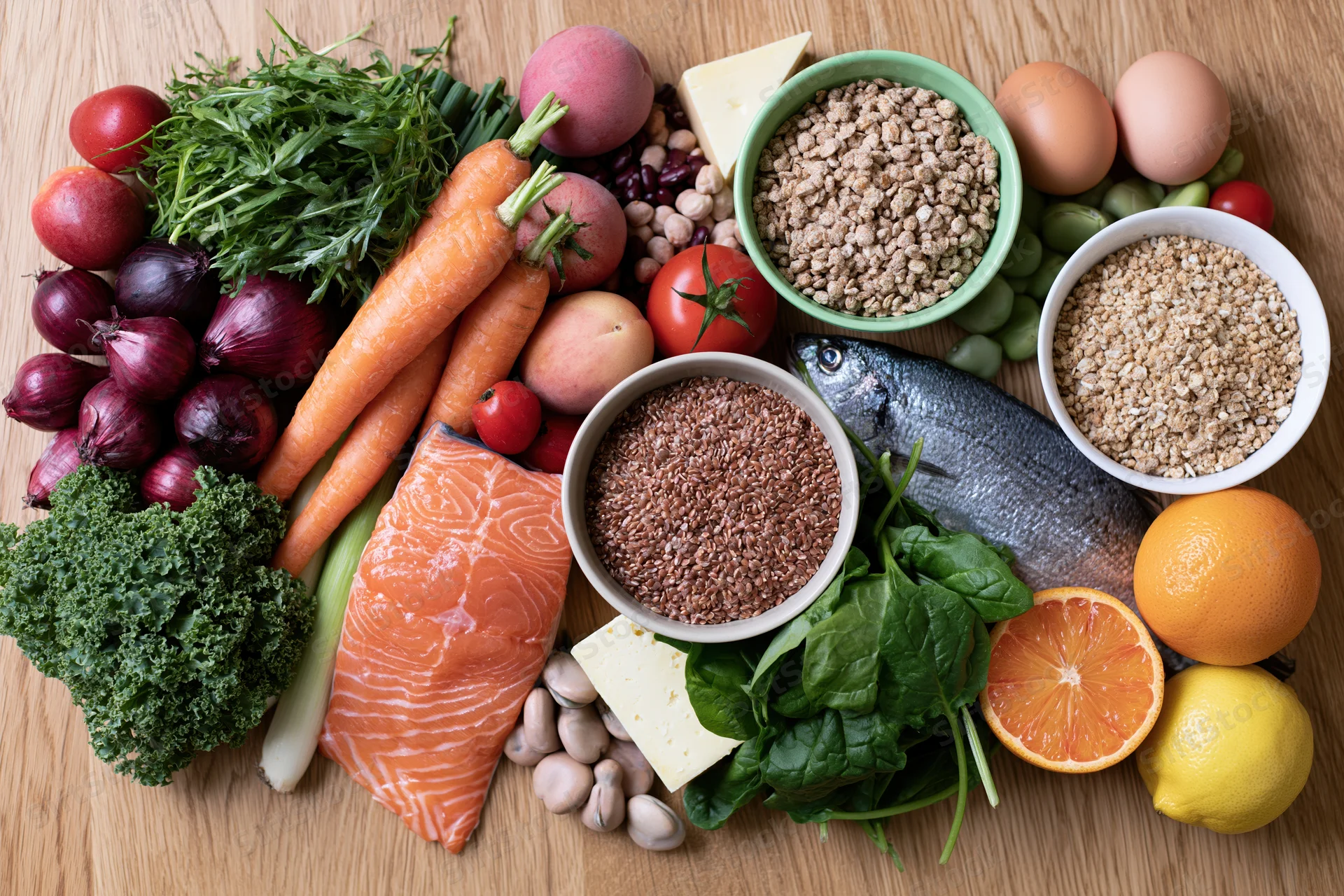 Flat lay of whole foods arranged on wooden table