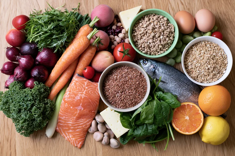 Flat lay of whole foods arranged on wooden table