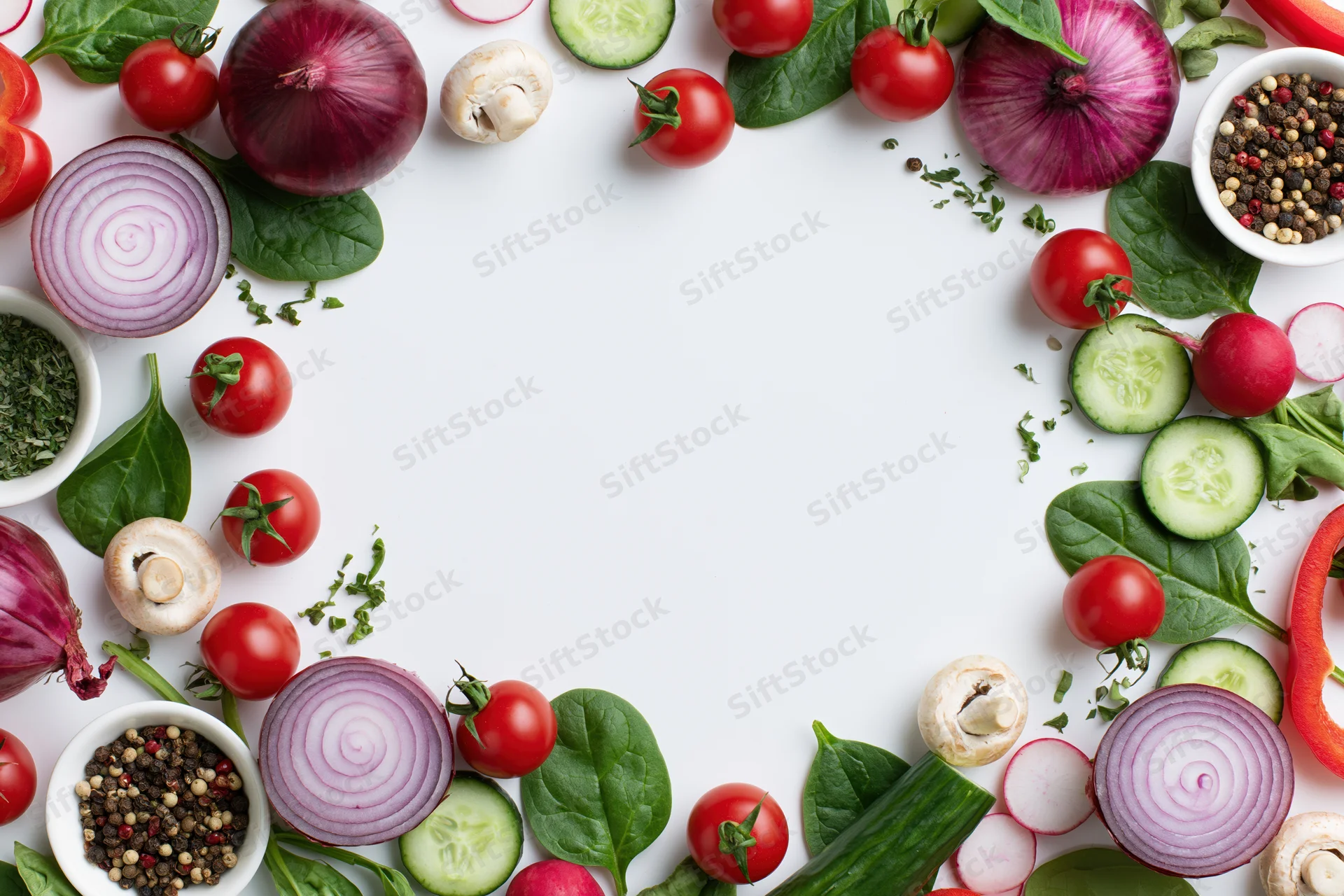 Fresh vegetables arranged in a border frame around a white copyspace