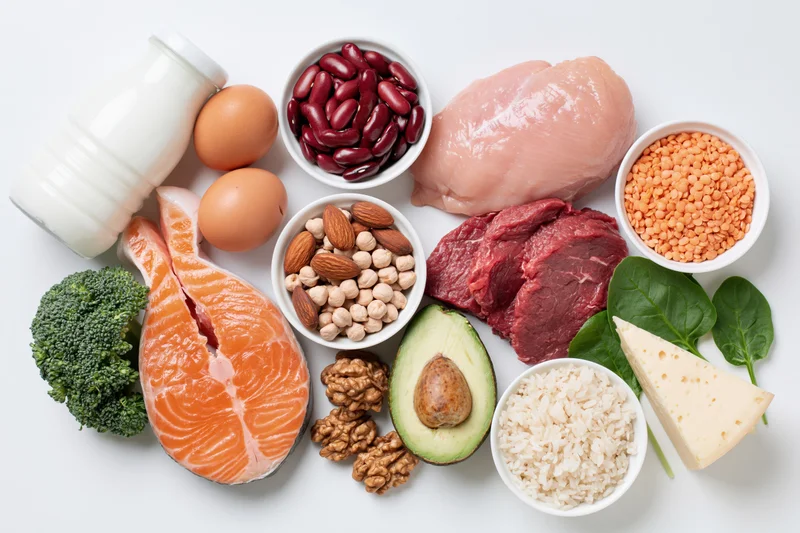 High-protein foods arranged in a flat lay on a white surface