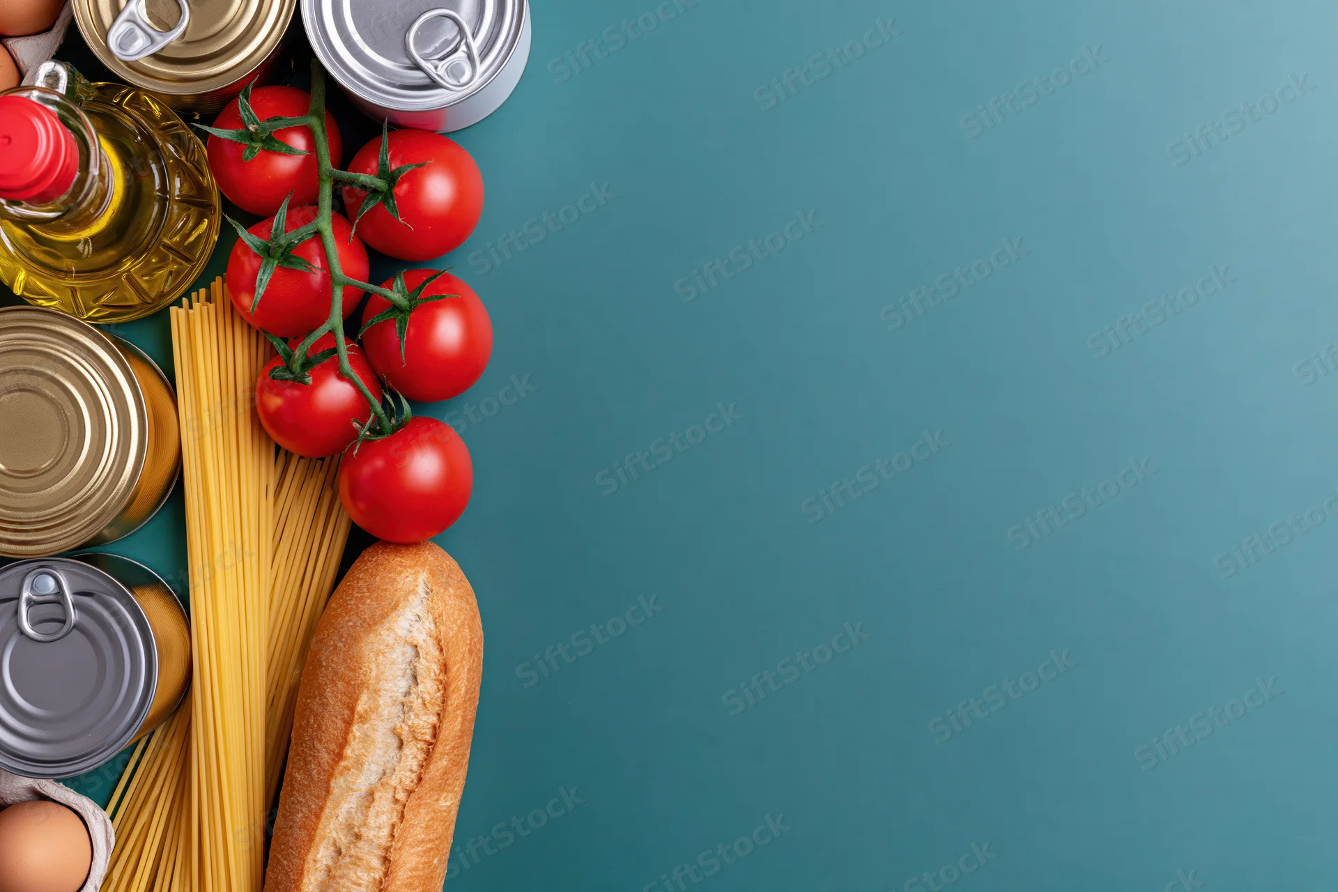 Pantry staples arranged along left edge on blue background with copyspace