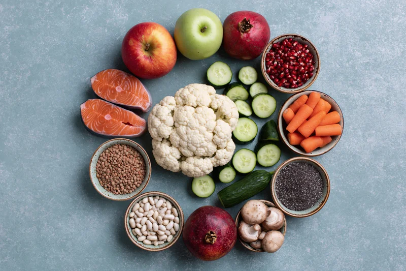 Assorted whole foods arranged in a circular pattern on a stone surface