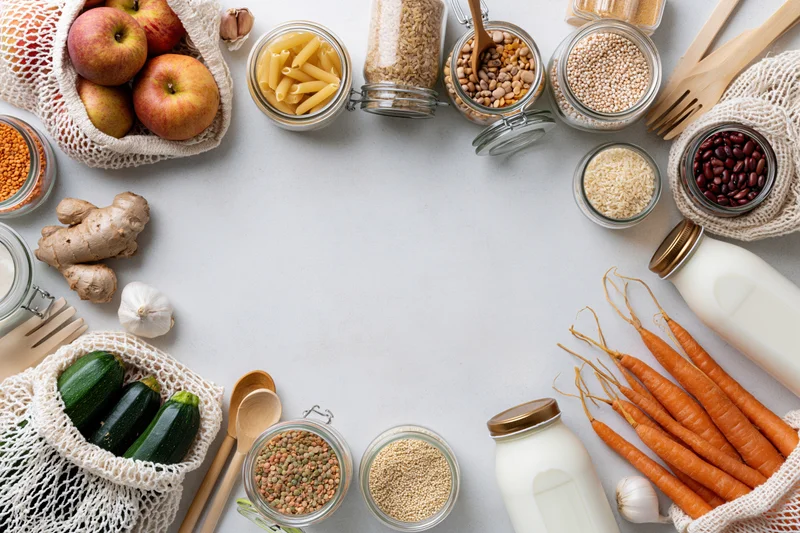 Zero-waste groceries arranged in a circle on a countertop with copyspace in center
