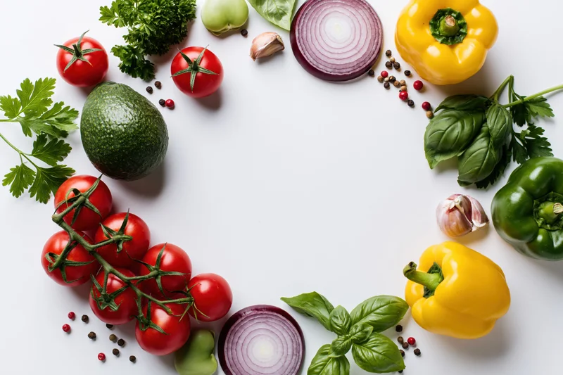 Fresh vegetables and herbs arranged in a loose circular border