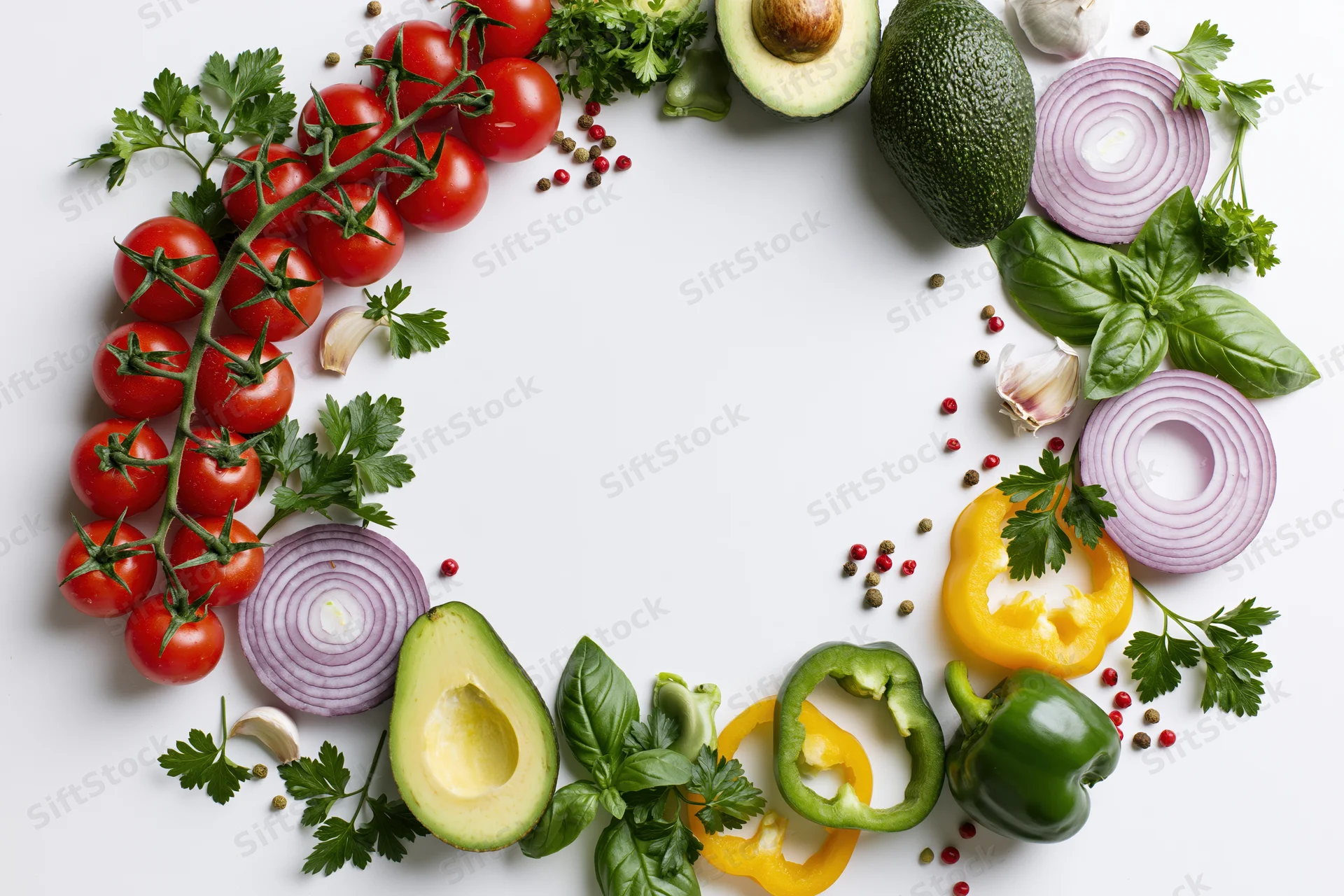 Fresh vegetables and herbs arranged in a loose circular border on white surface with copyspace
