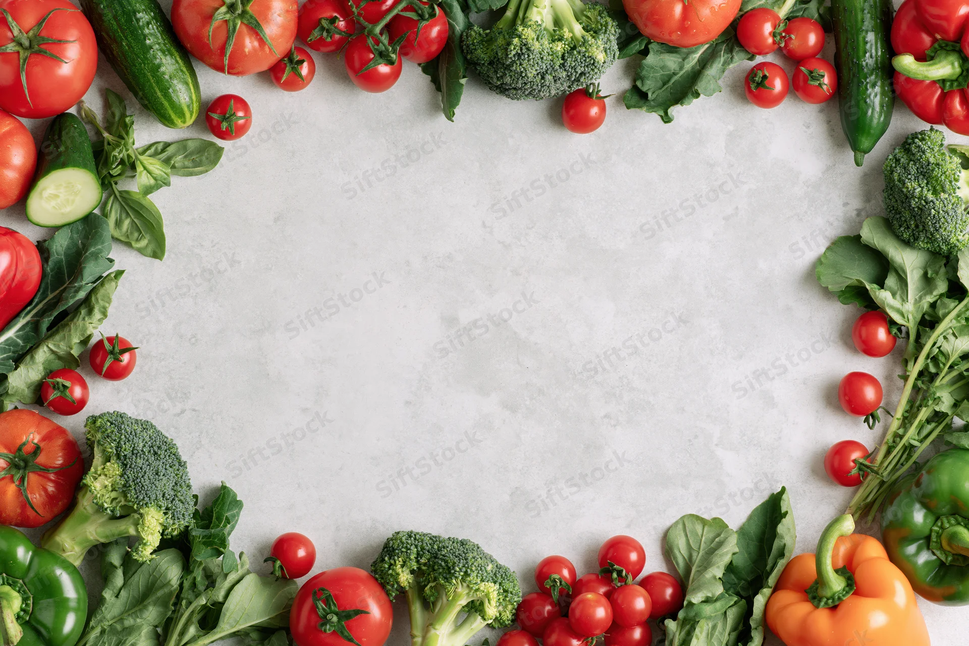 Fresh vegetables arranged in a border frame around a white countertop with copyspace in center