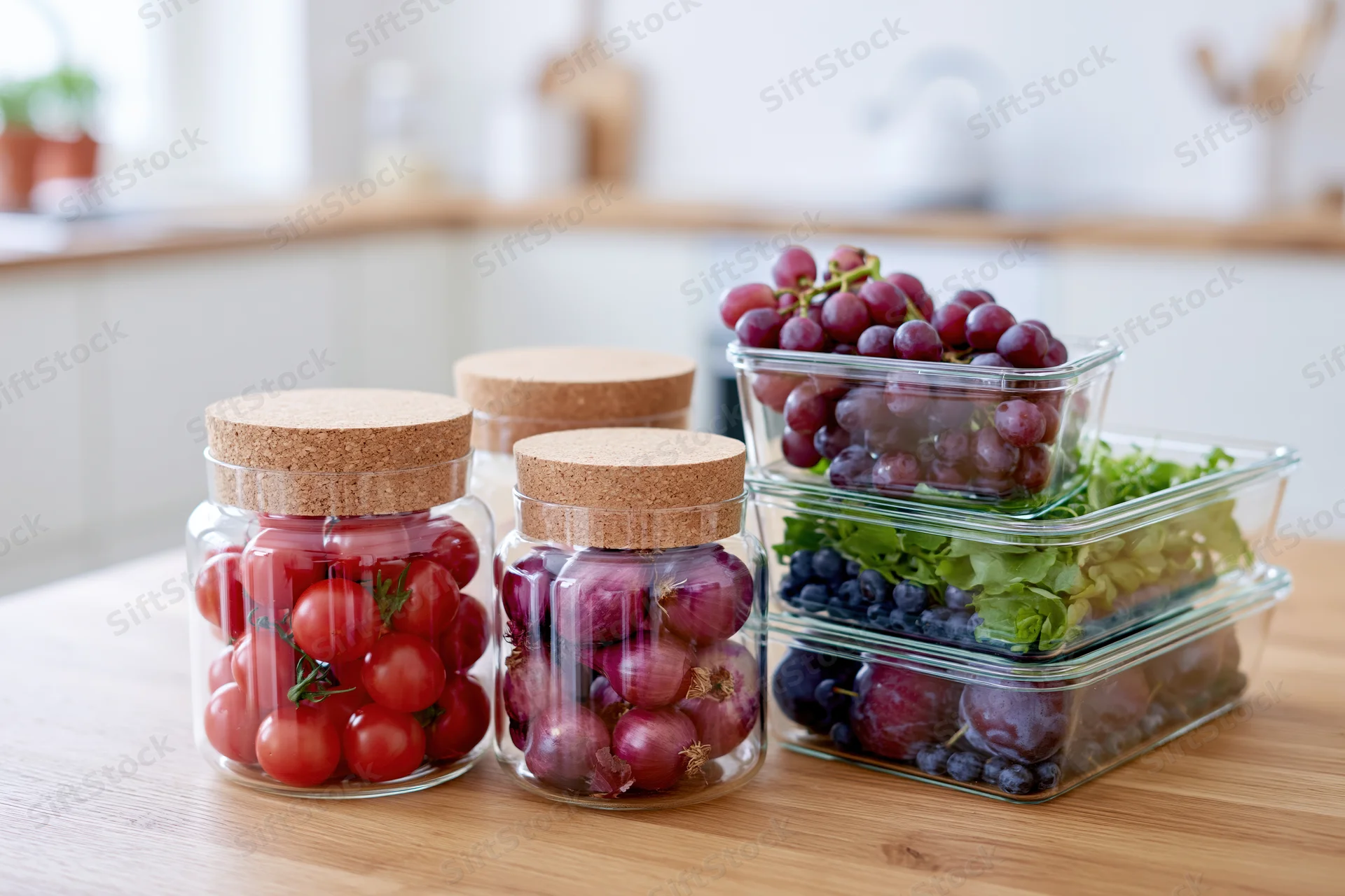 Glass jars with cork lids filled with cherry tomatoes and other produce arranged on a wooden kitchen countertop