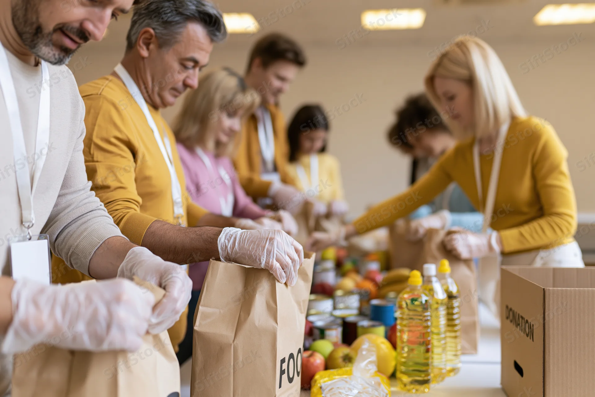 Volunteers packing food donations at a community table