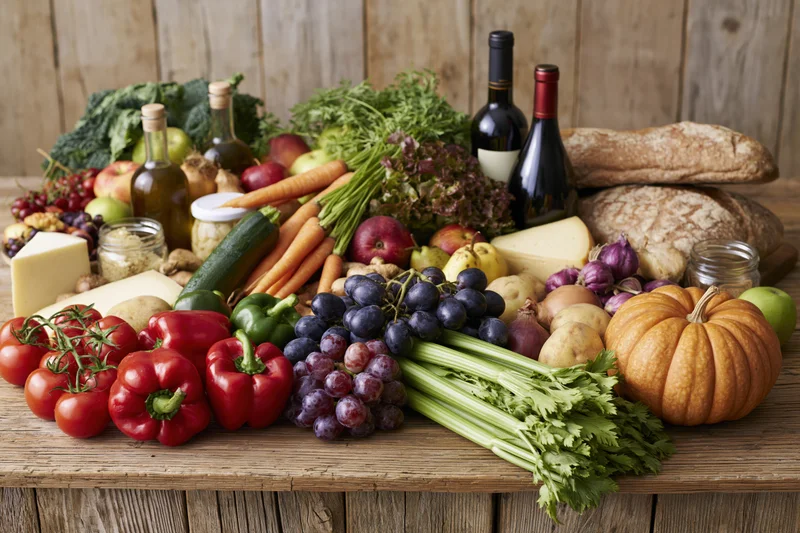 Fresh groceries arranged on a rustic wooden table