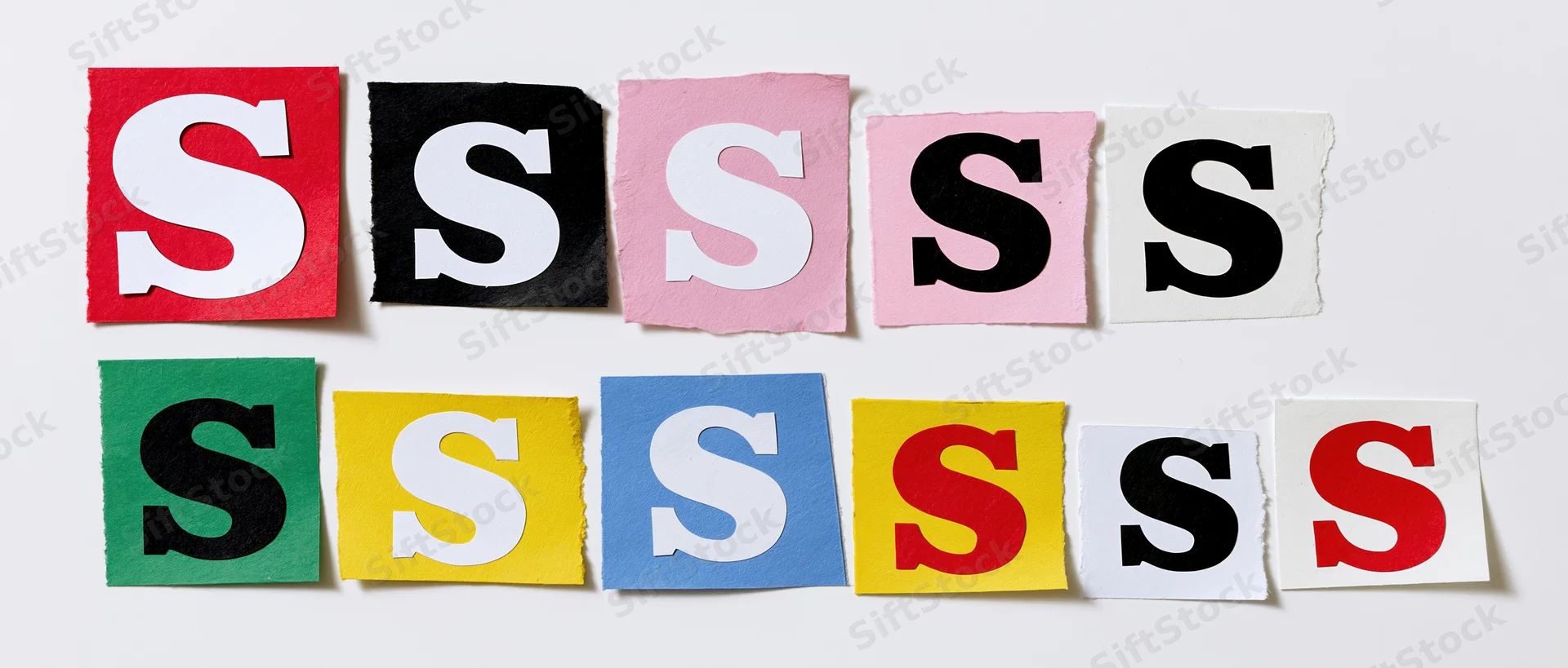 Cut-out letter s clippings arranged in two rows on white background