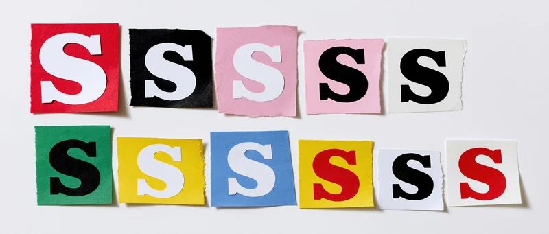 Cut-out letter s clippings arranged in two rows on white background