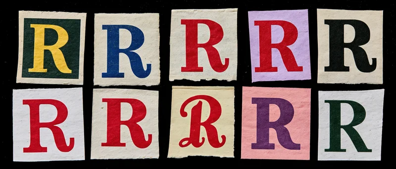 Nine cut-out paper squares each displaying the letter r in different fonts and colors arranged in two rows on a black background