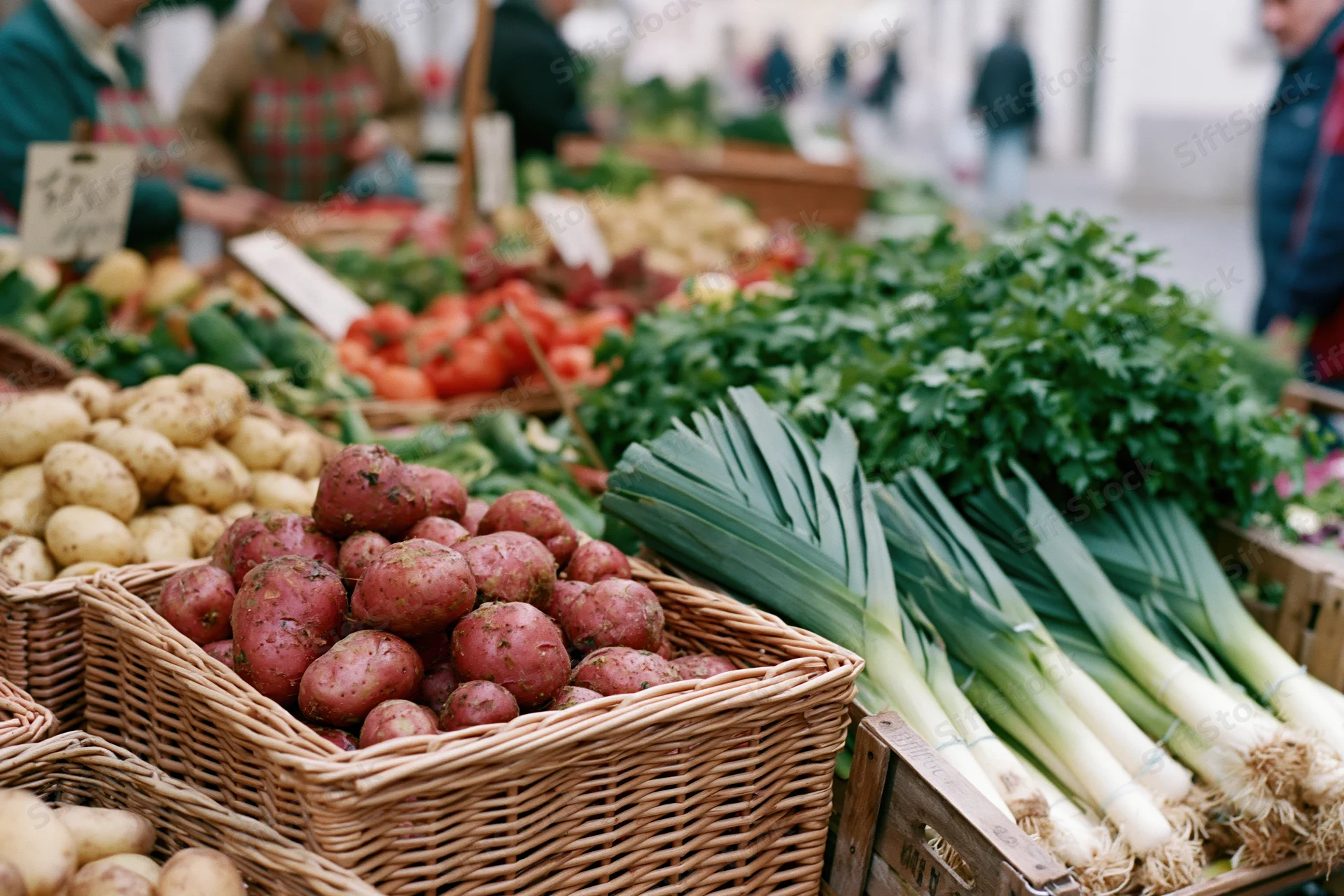 Fresh vegetables in wicker baskets and wooden crates at an outdoor market stall