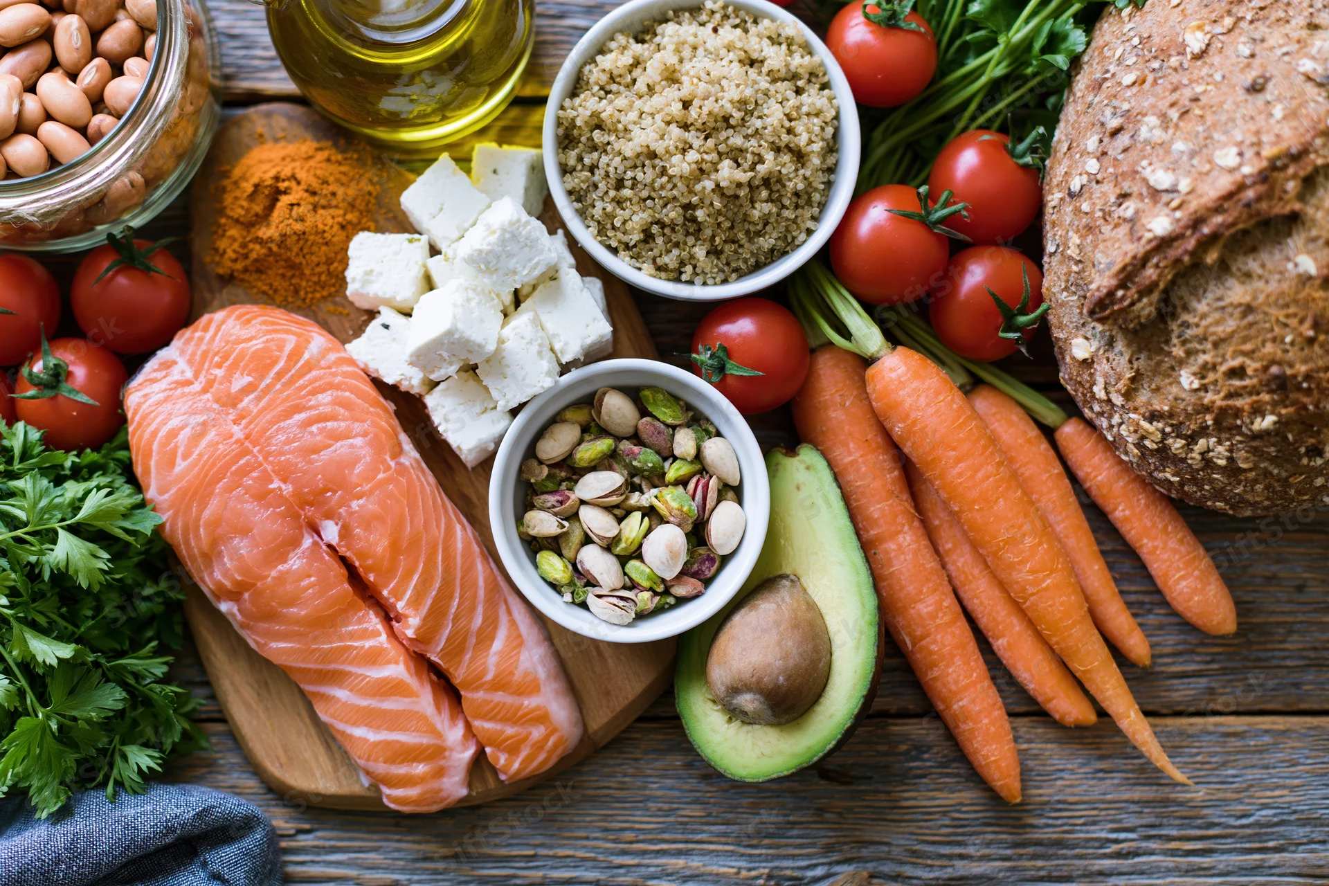 Overhead flat-lay of mediterranean diet ingredients arranged on wooden surface