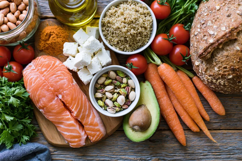 Overhead flat-lay of mediterranean diet ingredients arranged on wooden surface