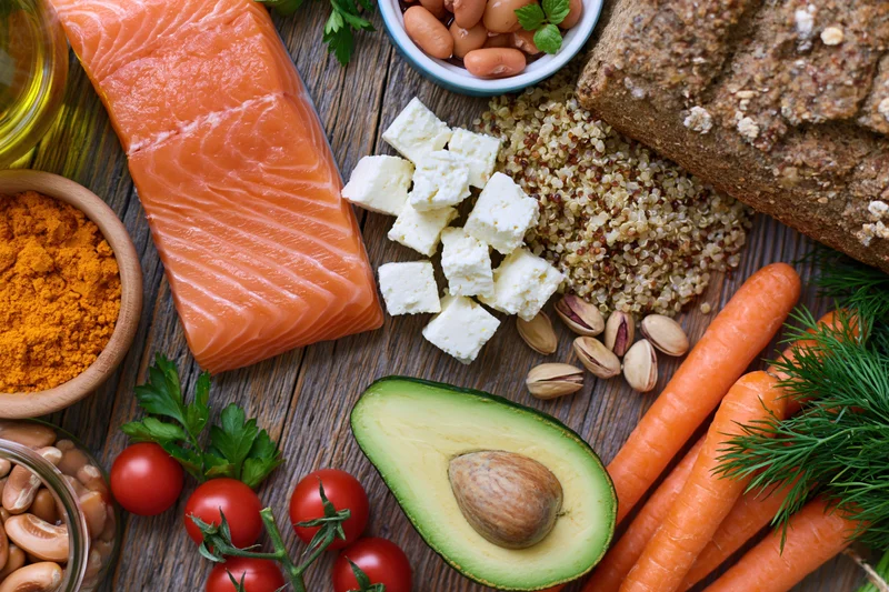 Overhead flat-lay of mediterranean diet ingredients arranged on wooden table