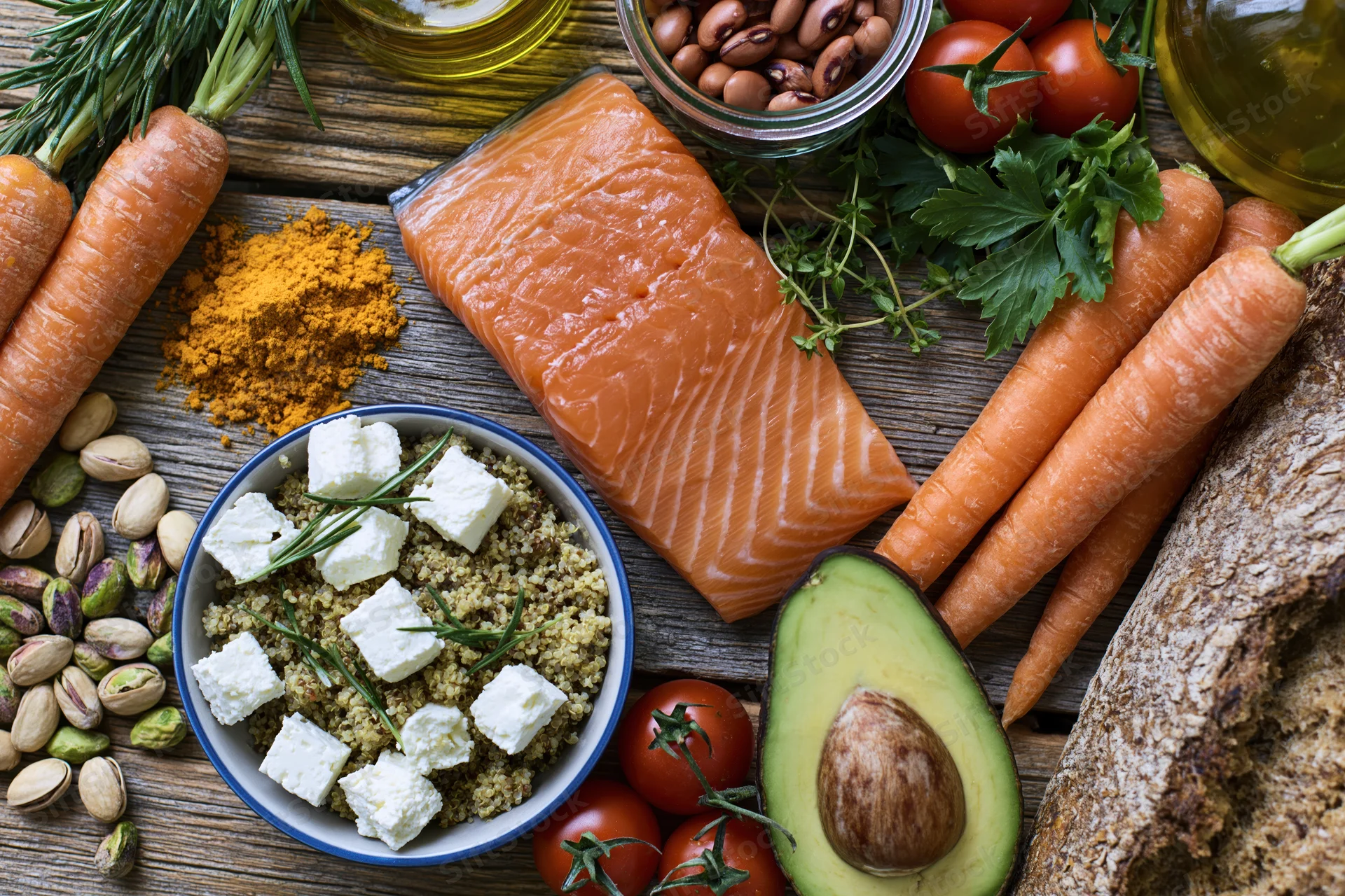 Overhead flat-lay of mediterranean diet ingredients arranged on wooden surface
