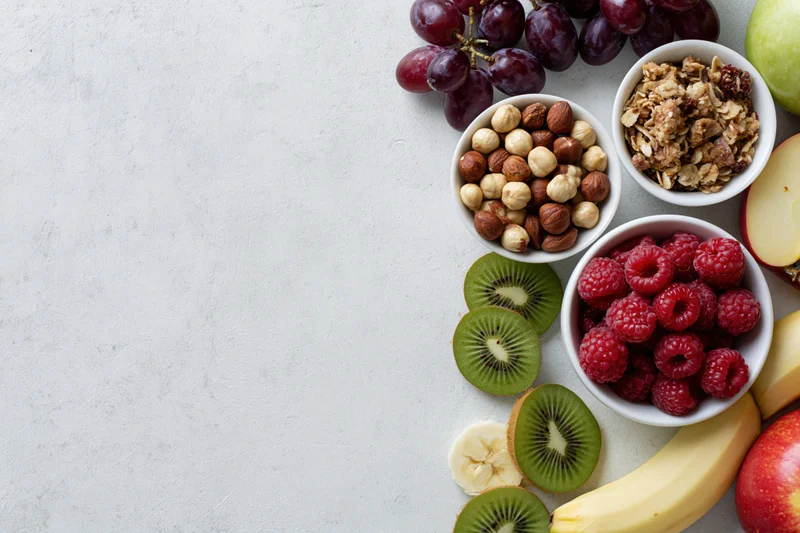 Breakfast ingredients arranged along the right side of a white surface in a flat lay overhead view