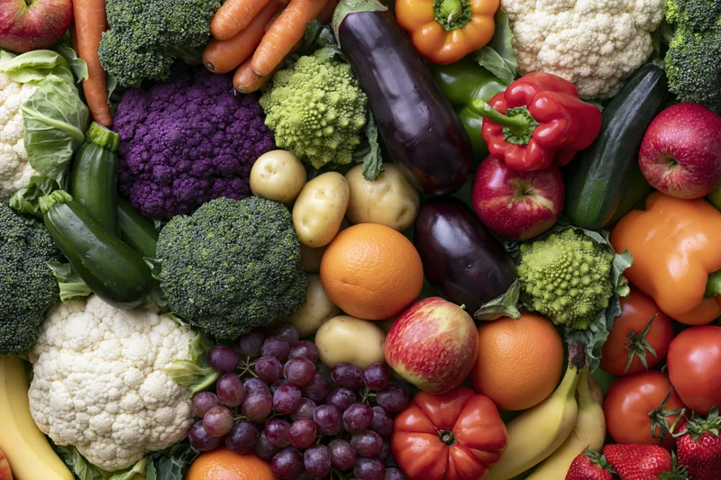 Overhead flat lay of densely packed fresh vegetables and fruits