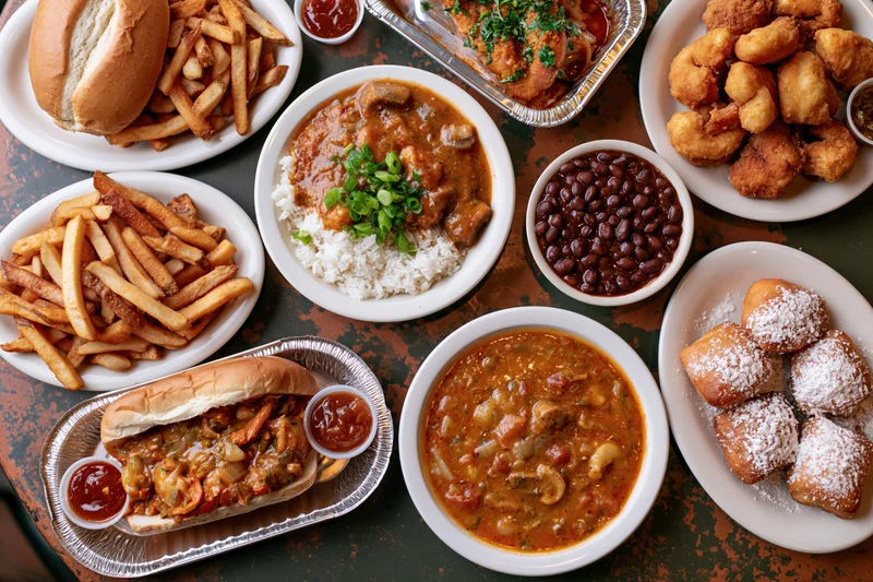 Overhead flat lay of multiple southern cajun restaurant dishes on a table