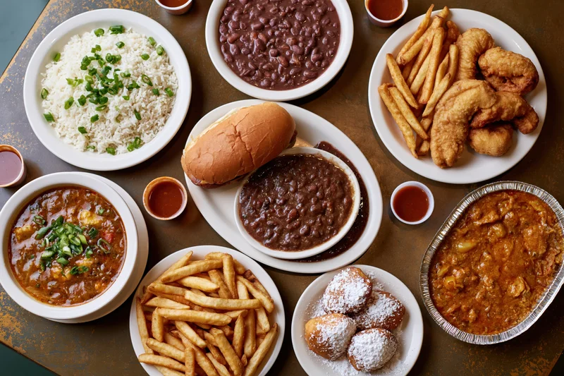 Overhead flat lay of multiple southern cajun restaurant dishes on a table
