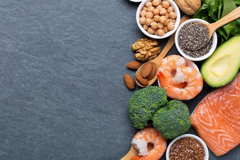 Omega-3 and protein-rich foods arranged in a flat lay on a slate surface with copyspace