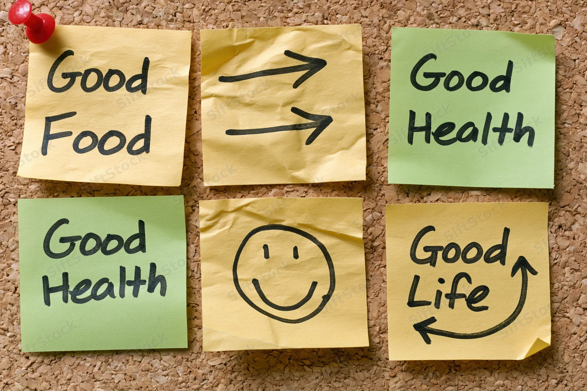 Six crumpled sticky notes with handwritten messages about good food, good health and good life arranged in a grid on a corkboard
