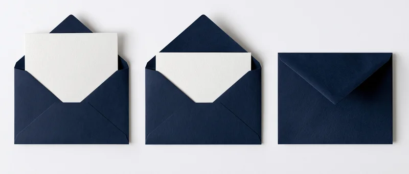 Three navy blue envelopes with white cards arranged in a row on a white surface